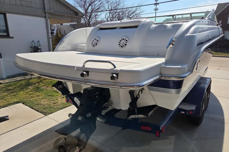 Slide: The Image of 2005 Formula 260 Sun Sport boat on trailer, rear view, parked in driveway. - 8