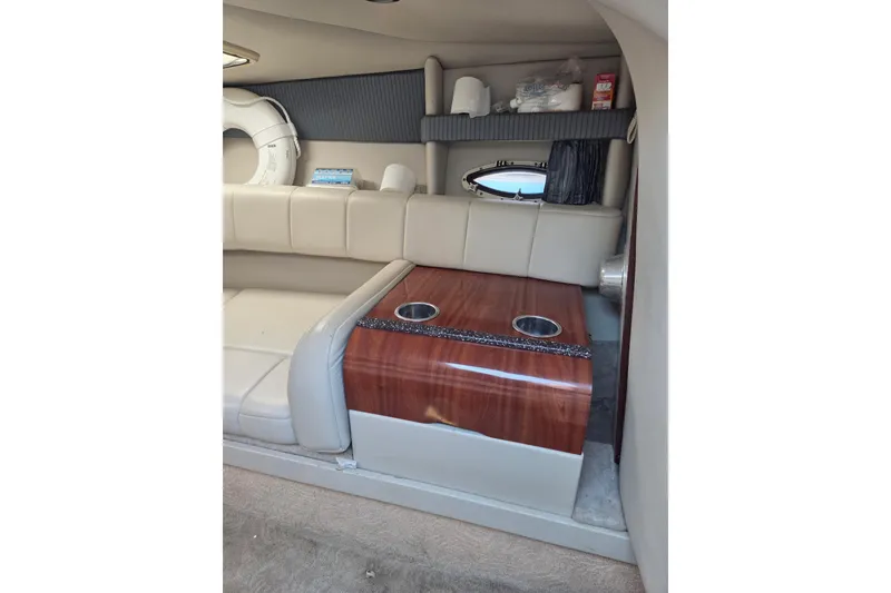 Slide: The Image of 2005 Formula 260 Sun Sport cabin interior with beige seating and wooden table. - 9