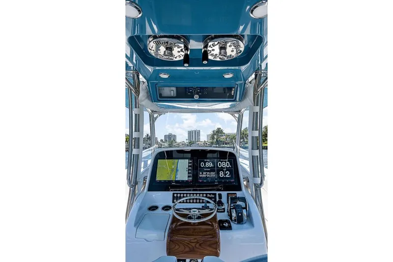 Slide: The Image of 2019 Mag Bay 33 CC boat helm with navigation screens and controls. - 12