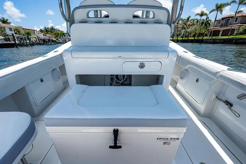 Slide: The Image of 2019 Mag Bay 33 CC boat interior with seating and storage, dockside view. - 17