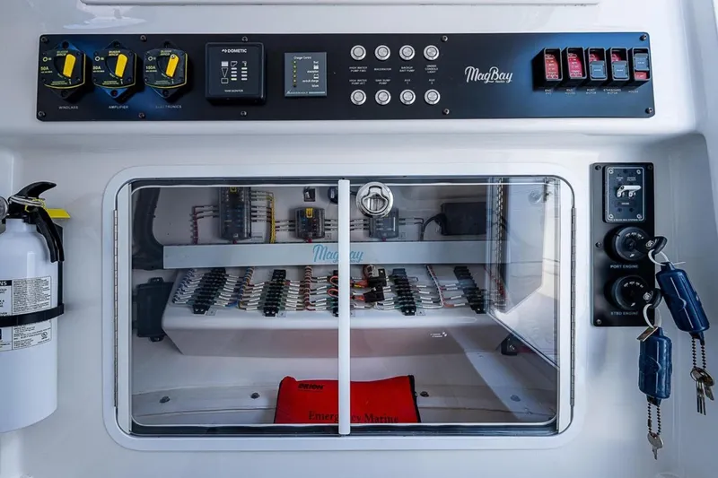 Slide: The Image of Control panel of 2019 Mag Bay 33 CC boat with safety equipment and keys. - 19