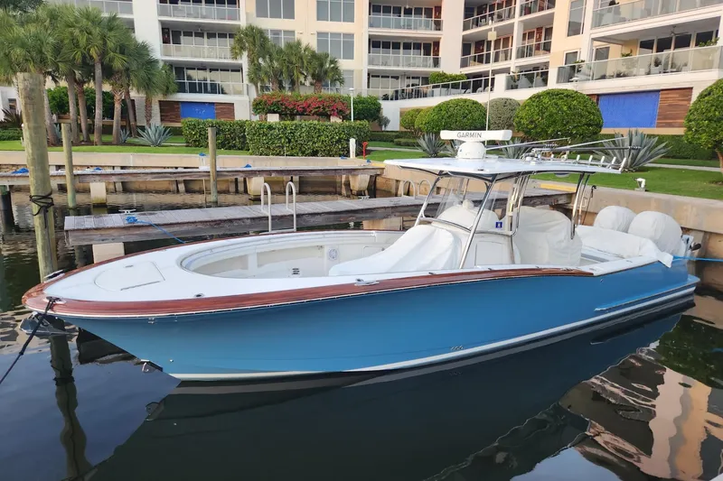 Slide: The Image of 2019 Mag Bay 33 CC boat docked near waterfront apartments. - 2