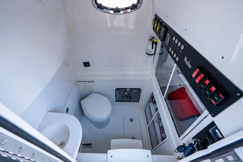 Slide: The Image of 2019 Mag Bay 33 CC boat interior with toilet, sink, and control panel. - 20