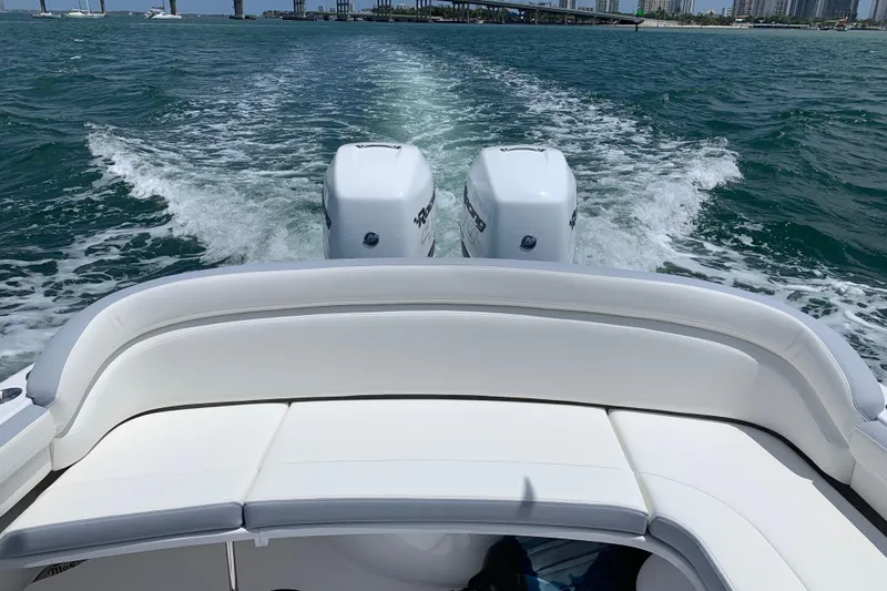 Slide: The Image of 2019 Mag Bay 33 CC boat cruising with twin engines on open water. - 3