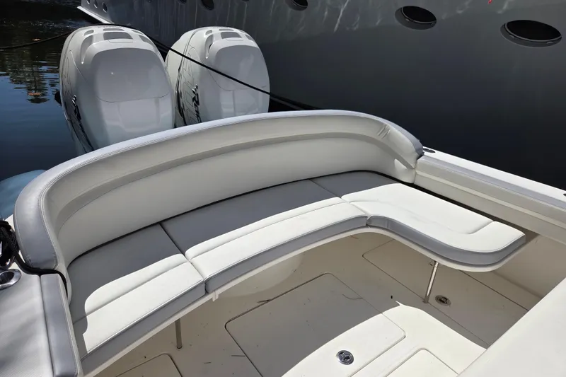 Slide: The Image of 2019 Mag Bay 33 CC boat with white cushioned seating and dual outboard engines. - 4