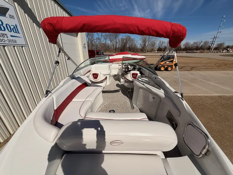 Slide: The Image of Interior view of a 2012 Crownline 252 EX boat with red sunshade. - 10