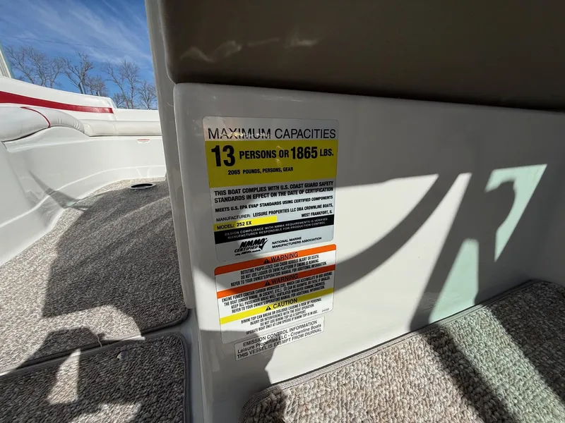 Slide: The Image of Crownline 252 EX 2012 boat capacity label, maximum 13 persons or 1865 pounds. - 18
