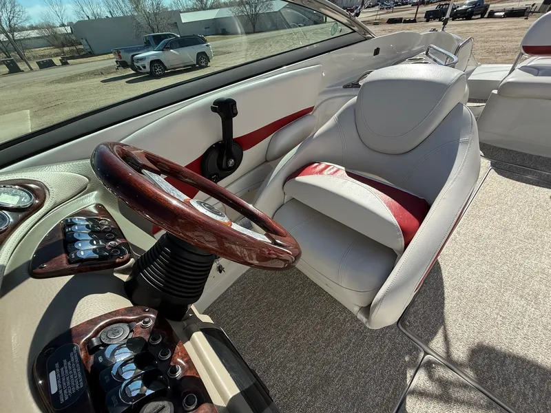 Slide: The Image of Interior of a 2012 Crownline 252 EX boat with steering wheel. - 19