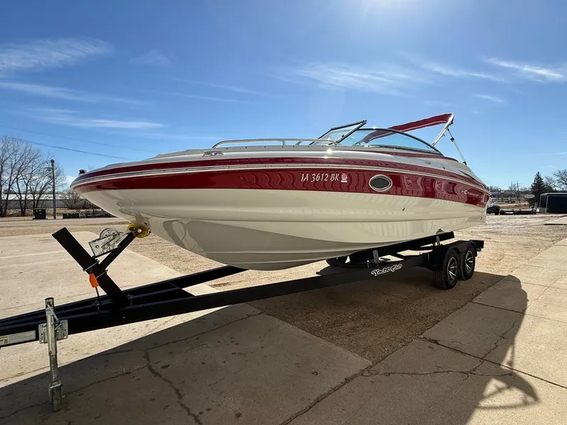 Slide: The Image of 2012 Crownline 252 EX boat on trailer in sunny weather. - 2