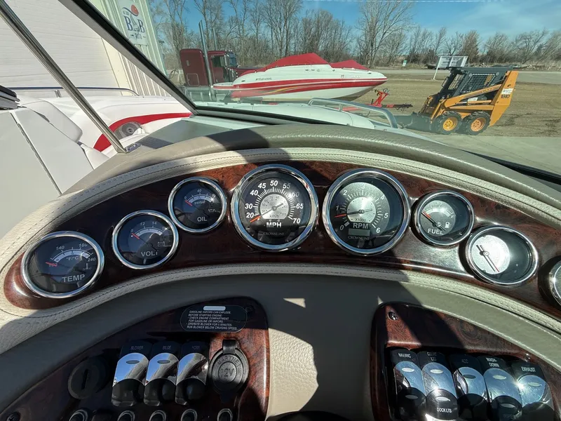 Slide: The Image of Dashboard of a 2012 Crownline 252 EX boat with gauges. - 22