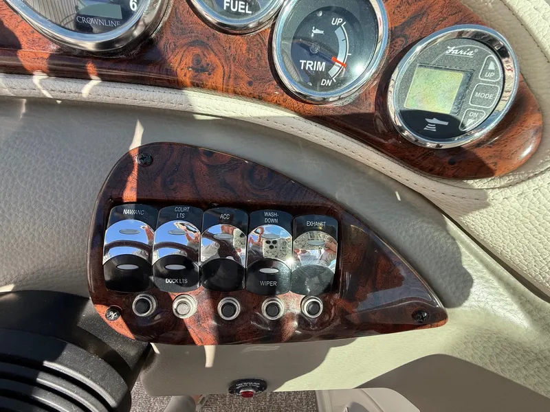 Slide: The Image of Dashboard of a 2012 Crownline 252 EX boat with switches. - 24