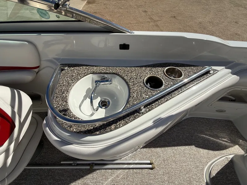 Slide: The Image of Interior of 2012 Crownline 252 EX with sink and cup holders. - 30