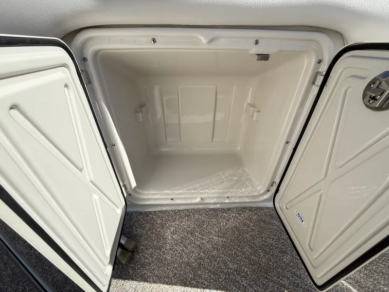 Slide: The Image of Open storage compartment in 2012 Crownline 252 EX boat. - 31