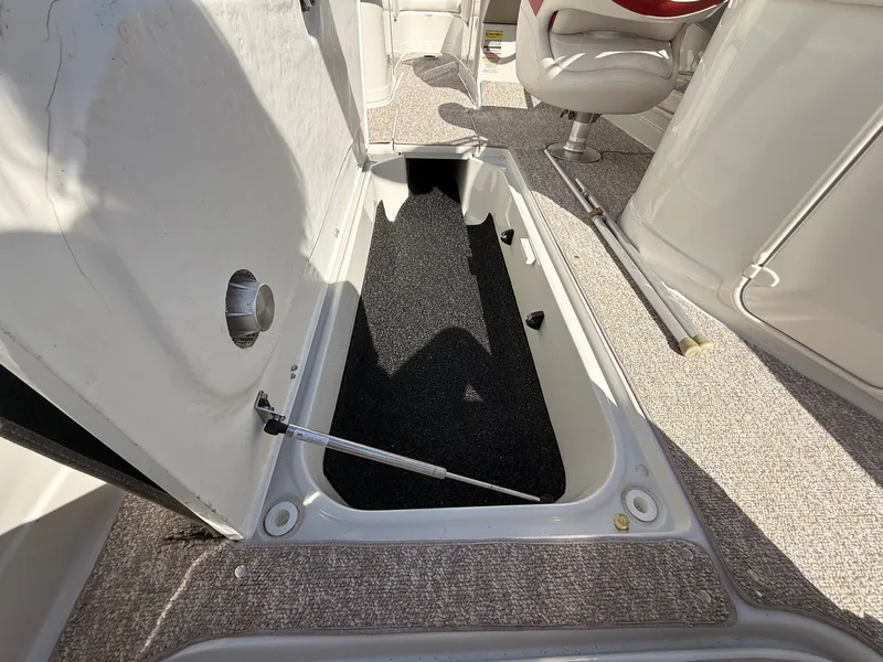 Slide: The Image of Open storage compartment in 2012 Crownline 252 EX boat. - 37