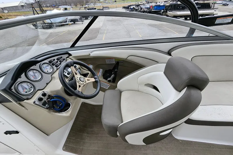Slide: The Image of 2013 Yamaha Boats 242 Limited cockpit with steering wheel and gauges, featuring comfortable seating. - 10
