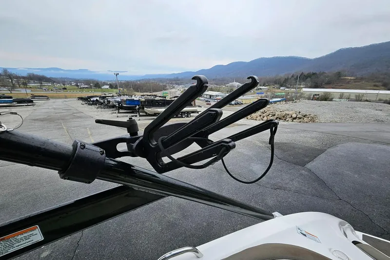 Slide: The Image of 2013 Yamaha Boats 242 Limited with wakeboard rack, mountain view in background. - 3