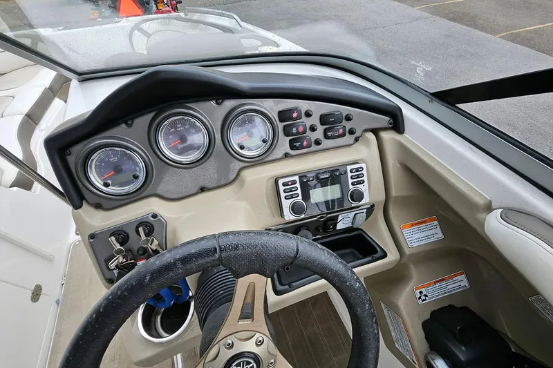 Slide: The Image of 2013 Yamaha Boats 242 Limited dashboard with gauges and controls, featuring a steering wheel. - 7