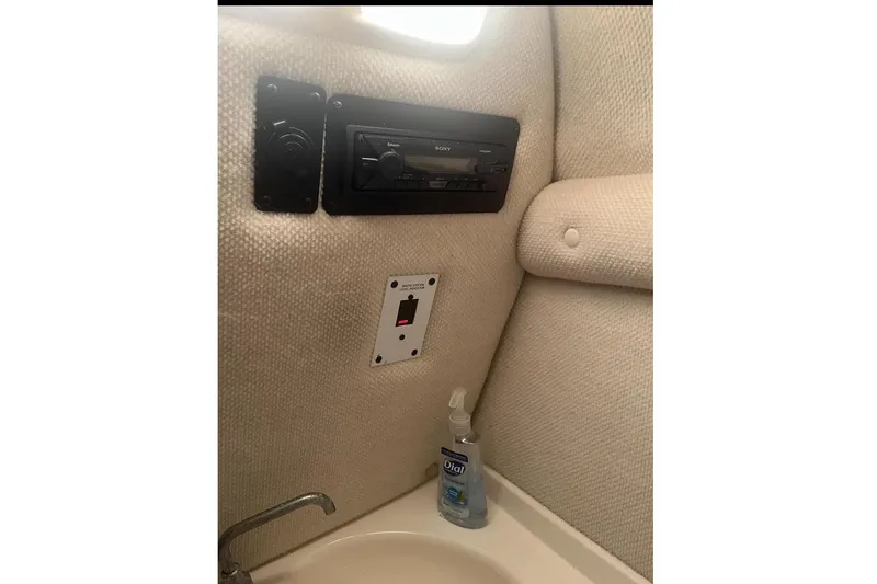 Slide: The Image of Interior of 2004 Chaparral 260 SSi with radio and sink. - 12