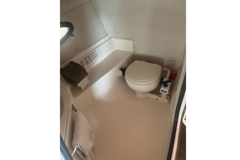 Slide: The Image of Interior of a 2004 Chaparral 260 SSi featuring a toilet. - 13