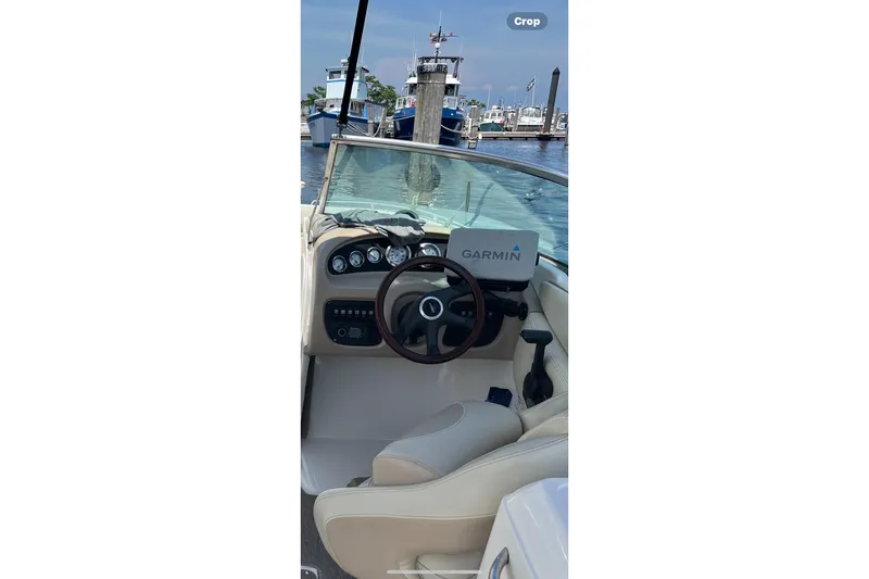 Slide: The Image of 2004 Chaparral 260 SSi boat interior with Garmin navigation, docked at marina. - 5