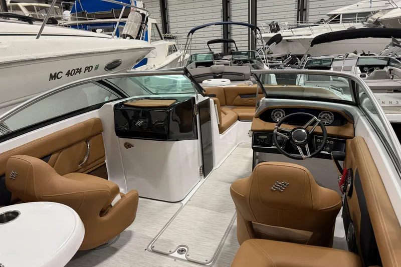 Slide: The Image of 2025 Four Winns HD3 boat interior with tan leather seats and modern dashboard. - 11