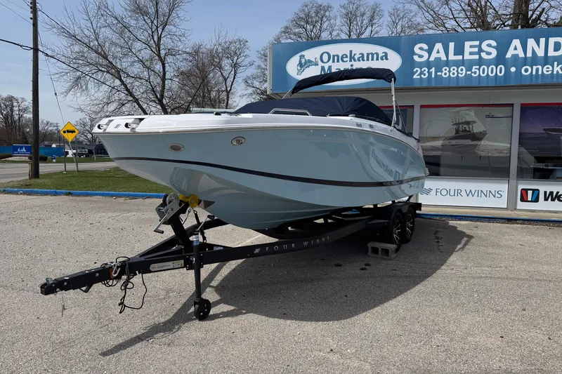 Slide: The Image of 2025 Four Winns HD3 boat on trailer at Onekama Marine dealership. - 2