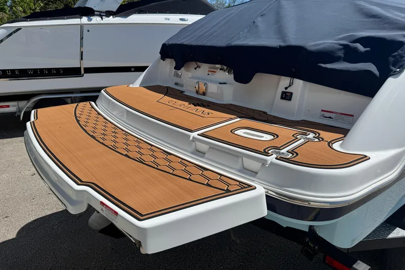 Slide: The Image of 2025 Four Winns HD3 boat with teak-style swim platform and covered seating area. - 3