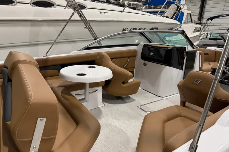 Slide: The Image of 2025 Four Winns HD3 boat interior with tan seating and a white table. - 9