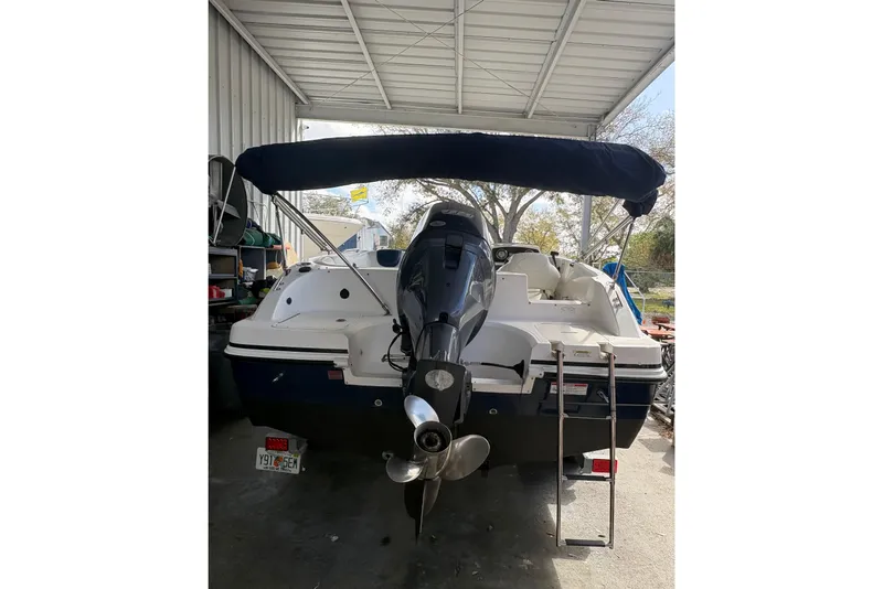 Slide: The Image of 2014 Hurricane SunDeck 187 OB boat interior with white and blue seating. - 5