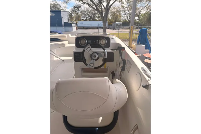 Slide: The Image of 2014 Hurricane SunDeck 187 OB boat on trailer, parked outdoors. - 2