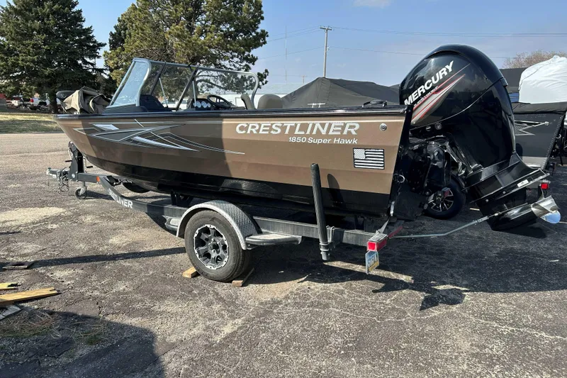 The Image of 2017 Crestliner 1850 Super Hawk boat on trailer, featuring Mercury outboard motor. - 1