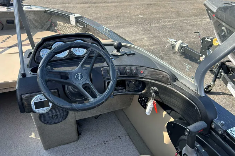 Slide: The Image of 2017 Crestliner 1850 Super Hawk boat dashboard with steering wheel and control panel. - 7