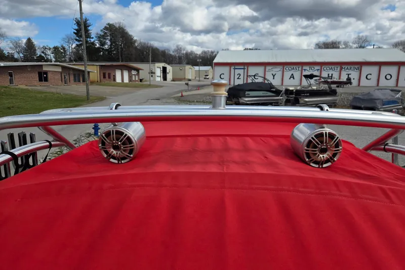 Slide: The Image of 2005 Yamaha Boats AR230 with red cover and speakers, parked at Coast to Coast Marine. - 13