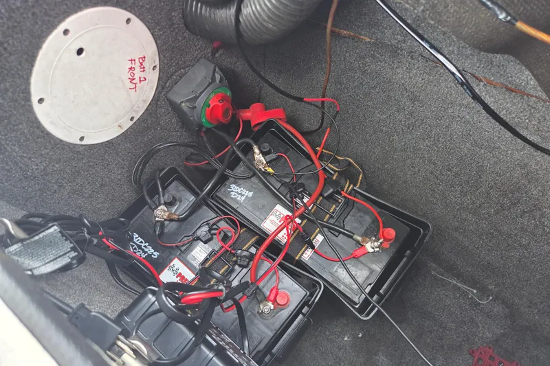 Slide: The Image of Battery compartment of a 2005 Yamaha Boats AR230 with wiring and connections visible. - 16
