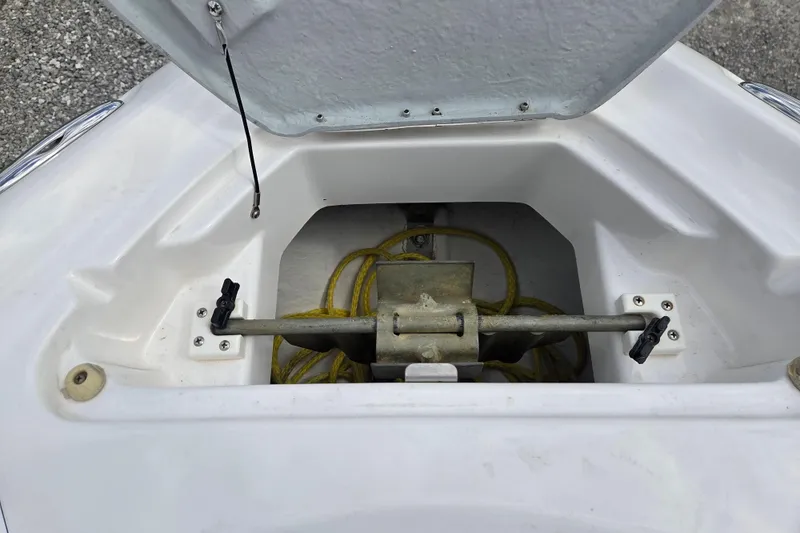 Slide: The Image of Open anchor compartment of 2005 Yamaha Boats AR230 with yellow rope inside. - 19
