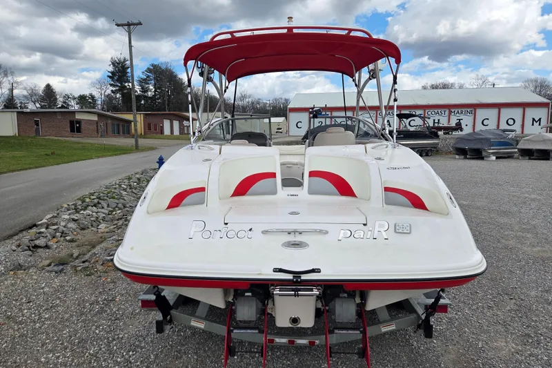 Slide: The Image of 2005 Yamaha Boats AR230 with red canopy, parked outdoors on gravel. - 3