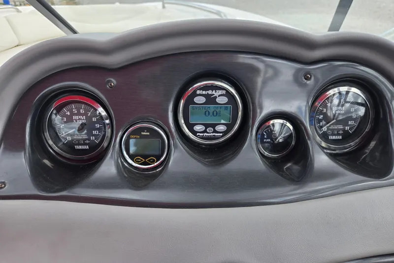 Slide: The Image of Dashboard of a 2005 Yamaha Boats AR230 with gauges and controls. - 7