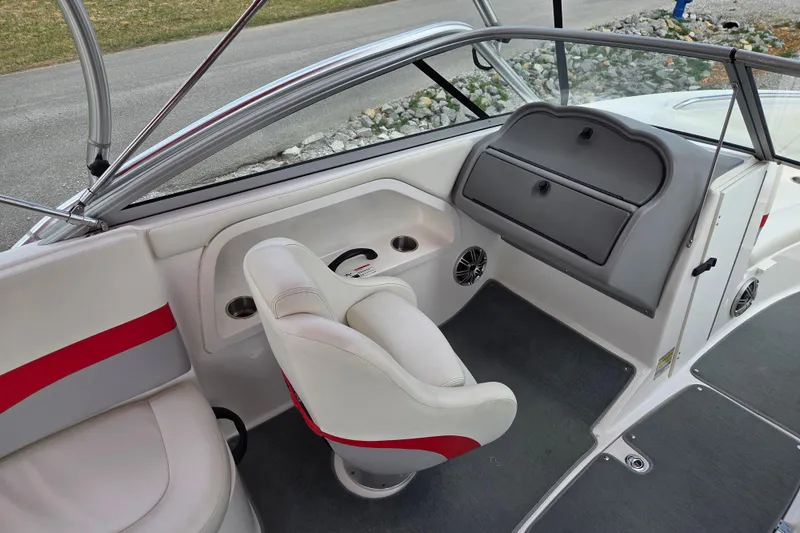 Slide: The Image of 2005 Yamaha AR230 boat interior with white and red seating, dashboard, and storage compartments. - 8