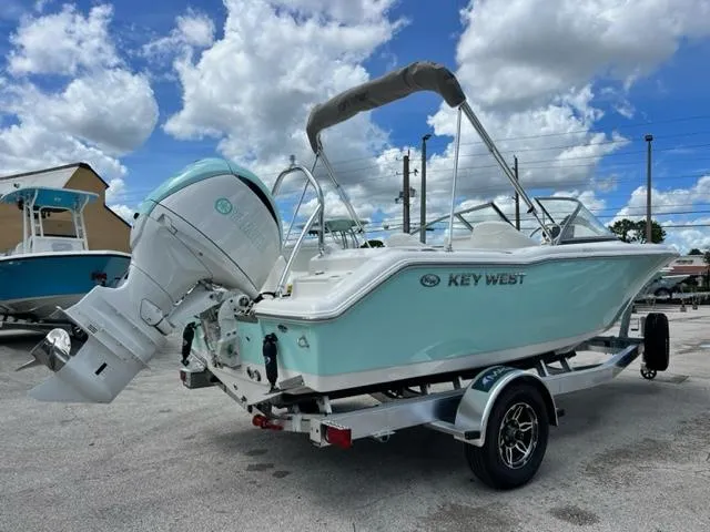 Slide: The Image of 2024 Key West 203 DFS boat on trailer under blue sky. - 4