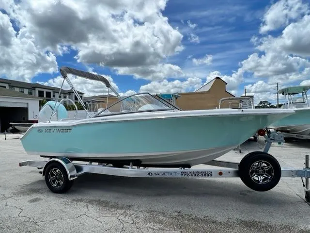 Slide: The Image of 2024 Key West 203 DFS boat on trailer under blue sky. - 6