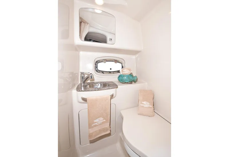 Slide: The Image of Manufacturer Provided Image: 2013 Chaparral 310 Signature boat bathroom with sink, mirror, and towels. - 12