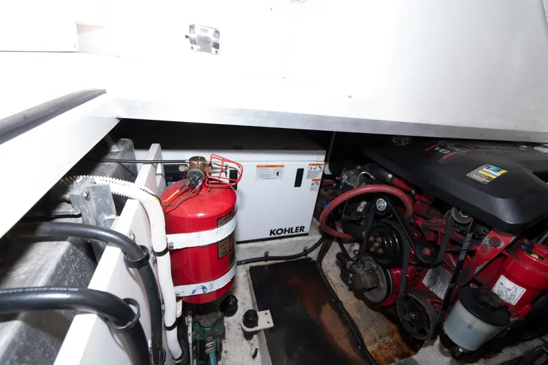 Slide: The Image of Engine compartment of 2013 Chaparral 310 Signature with Kohler generator and fire extinguisher. - 16