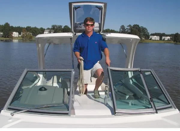 Slide: The Image of Manufacturer Provided Image: Man standing on a 2013 Chaparral 310 Signature boat on a lake. - 3