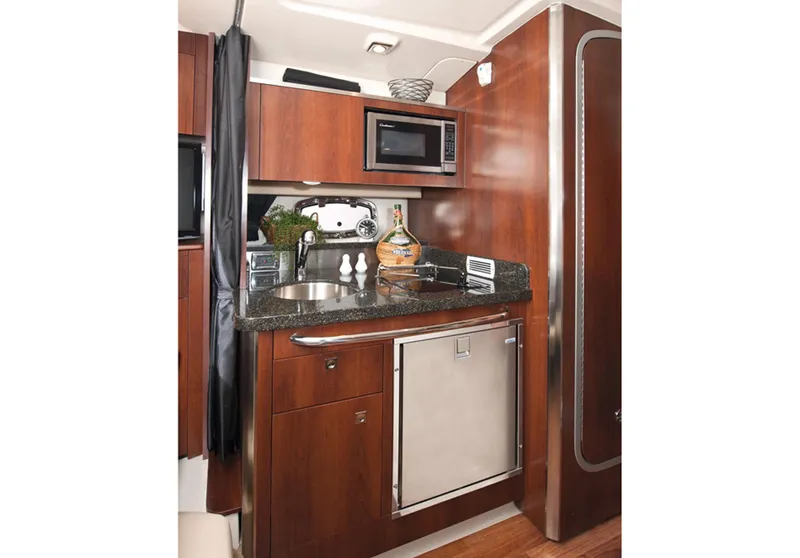 Slide: The Image of Manufacturer Provided Image: 2013 Chaparral 310 Signature boat kitchen with microwave, sink, and refrigerator. - 9