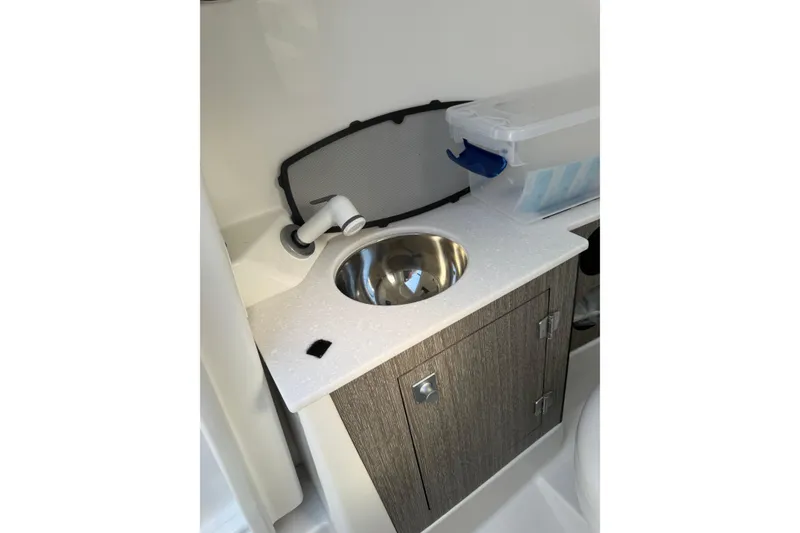 Slide: The Image of 2020 Monterey 255SS Super Sport boat interior with sink and storage cabinet. - 13