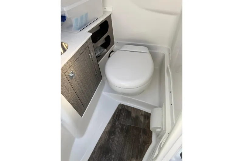 Slide: The Image of 2020 Monterey 255SS Super Sport boat bathroom with toilet and wooden cabinet. - 14