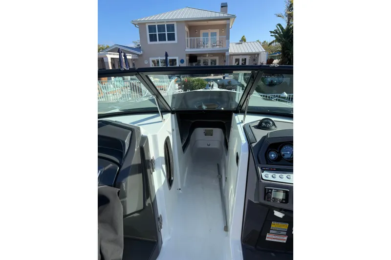 Slide: The Image of 2020 Monterey 255SS Super Sport boat interior with dashboard, near waterfront home. - 7