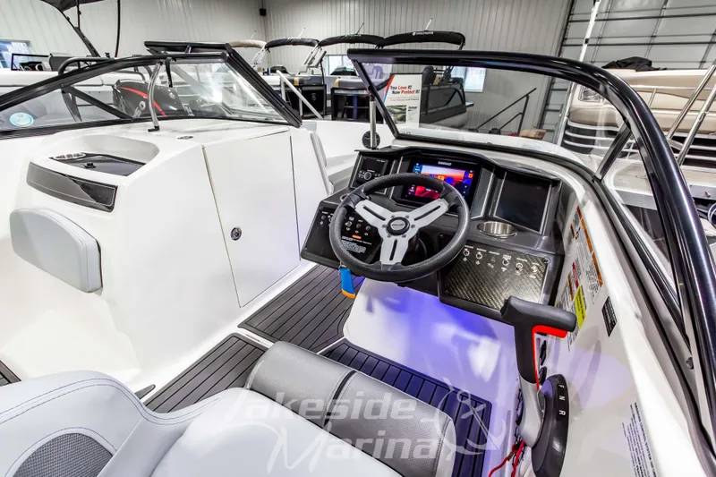 Slide: The Image of 2023 Bayliner VR6 Bowrider I/O interior with steering wheel and dashboard controls. - 21