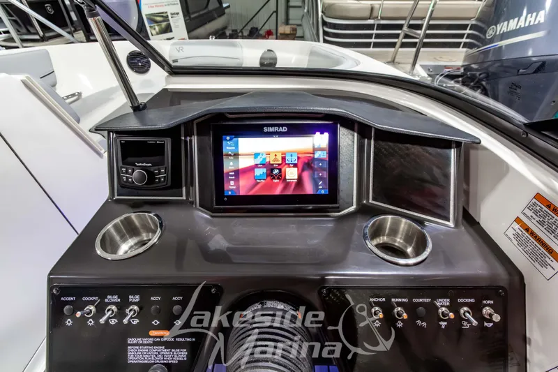Slide: The Image of 2023 Bayliner VR6 Bowrider I/O dashboard with Simrad display and control panel. - 22