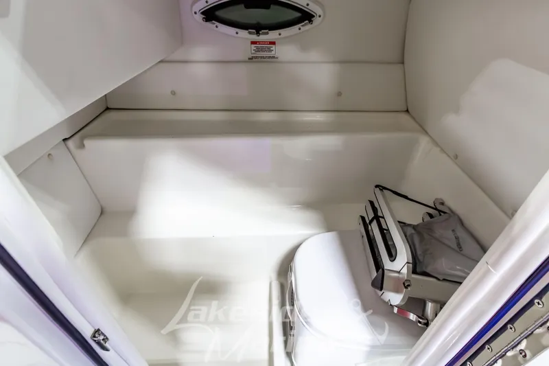 Slide: The Image of 2023 Bayliner VR6 Bowrider I/O interior storage compartment with window and equipment. - 30